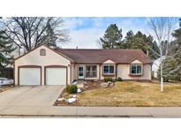Charming single-story home with a two-car garage and well-maintained front yard at 6933 S Dahlia St, Centennial, CO 80122