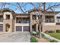 Charming townhome with stone accents, two car garage, and balcony views at 2405 Calais Dr # 18A, Longmont, CO 80504