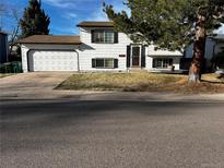 Charming two-story home with a two-car garage and a well-maintained front lawn at 9135 W Maplewood Ave, Littleton, CO 80123