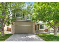 Charming two-story home with a well-maintained lawn and an attached two-car garage at 9737 Canberra Ct, Highlands Ranch, CO 80130