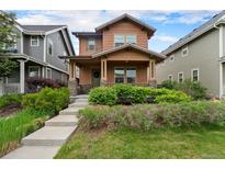 Charming two-story home with a welcoming front porch and meticulously landscaped front yard in a desirable neighborhood at 5434 N Xenia St, Denver, CO 80238