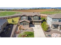 Beautiful home featuring professional landscaping, a two-car garage, and a wonderful backyard view at 853 Stagecoach Dr, Lafayette, CO 80026