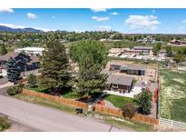 Charming home featuring beautiful landscaping, mature trees, horse property, and mountain views at 16225 W 74Th Dr, Arvada, CO 80007