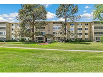 Charming multi-story building with mature trees and well-maintained landscaping and inviting entryway at 725 S Alton Way # 9C, Denver, CO 80247