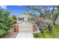 Charming two-story home features a brick-accented facade and a spacious two-car garage at 8441 S Timberwood St, Highlands Ranch, CO 80126