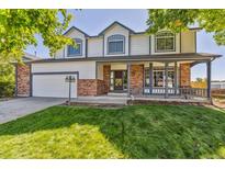 Charming two-story home featuring a well-manicured lawn and inviting front porch perfect for enjoying the outdoors at 5667 W 109Th Cir, Westminster, CO 80020