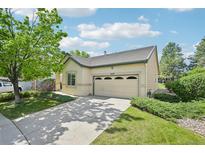 Charming single-Gathering home with an attached garage, mature tree, and well-manicured lawn at 2420 E 127Th Ave, Thornton, CO 80241