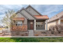 Charming home featuring a blend of modern design and natural textures with a copper roof and stone accents at 869 Bluestem Ln, Louisville, CO 80027