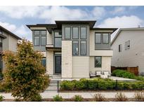 Stunning modern two-story home with stone accents, stylish windows, and a beautifully landscaped front yard at 5831 Galena St, Denver, CO 80238