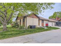 Charming single Gathering home with stucco siding and a well-maintained front yard at 671 Brentwood St, Lakewood, CO 80214