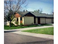 Single story home boasts mature trees, a green lawn and a private entrance at 671 Brentwood St, Lakewood, CO 80214