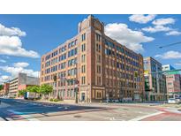 Beautiful brick building exterior with large windows and classic architectural details under a bright blue sky at 1863 Wazee St # 6B, Denver, CO 80202