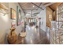 Spacious hallway with high ceilings, unique decor, and views into the main living area at 1863 Wazee St # 6B, Denver, CO 80202