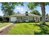 Charming single-story home featuring a well-maintained lawn, carport, and welcoming front porch at 4315 S Elati St, Englewood, CO 80110