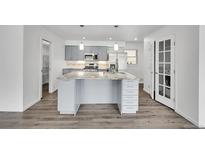 Modern kitchen featuring a large island with a granite countertop and stainless steel appliances at 641 E 104Th Pl, Northglenn, CO 80233