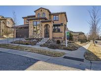 Charming two-story home with stone accents, landscaped front, and inviting curb appeal at 2256 S Isabell Ct, Lakewood, CO 80228