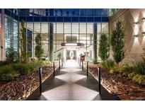 Modern building entrance with glass facade, landscape design, and inviting walkway leading to the lobby at 4200 W 17Th Ave # 611, Denver, CO 80204