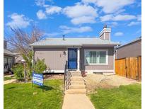 Charming single-story home with a blue front door, concrete steps, and well-maintained front lawn at 3782 S Genoa Cir # A, Aurora, CO 80013