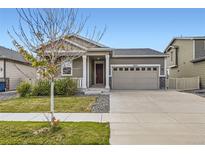 Charming single-Gathering home featuring a two-car garage and well-maintained front yard at 10555 Boston St, Commerce City, CO 80640