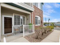 Charming porch with seating area perfect for enjoying the outdoors and welcoming guests to the residence at 2662 S Cathay Way # 112, Aurora, CO 80013