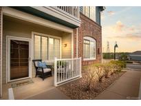 Inviting front porch features a chair and decor, adding charm to the home's exterior at 2662 S Cathay Way # 112, Aurora, CO 80013