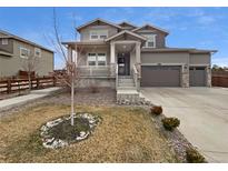Charming two-story home with a well-maintained front yard, porch, and attached two-car garage at 950 Avena Ct, Elizabeth, CO 80107