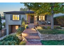 Charming home featuring inviting front porch, lush landscaping, and brick walkway at 1250 S Josephine St, Denver, CO 80210