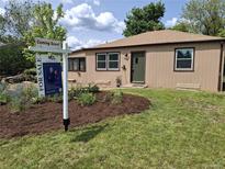 Cozy single-story home with fresh landscaping and 'For Sale' sign on a sunny day at 485 S Pierson St, Lakewood, CO 80226