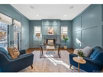 Beautiful office with blue walls, fireplace, natural light, and hardwood floors, creating a cozy, productive atmosphere at 1131 S York St, Denver, CO 80210