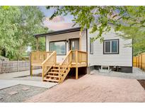 Charming home with a newly built wooden deck and fresh gravel landscaping at 261 Knox Ct, Denver, CO 80219