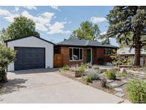Charming brick home featuring a well-manicured front yard and detached garage at 1695 S Beach Ct, Denver, CO 80219