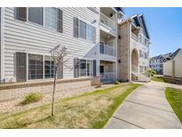 A beautiful condo building featuring multiple balconies and an inviting walkway at 15700 E Jamison Dr # 6-101, Englewood, CO 80112