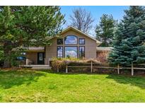 Inviting home showcasing large window, lush greenery, and well-maintained lawn at 182 Ridge Rd, Boulder, CO 80303