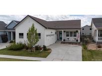 Charming single-Gathering home with a white exterior, a well-manicured lawn, and a two-car garage at 4422 Mt Shavano St, Brighton, CO 80601