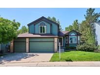 Charming two-story home with a three-car garage and mature landscaping at 5651 S Himalaya Way, Centennial, CO 80015
