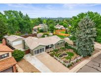 Charming single-story home with beautiful landscaping, mature trees, and a spacious driveway at 6811 S Clermont Dr, Centennial, CO 80122
