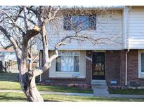 Brick townhouse exterior with a front door and landscaping at 13030 E Kansas Pl, Aurora, CO 80012