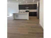 Modern kitchen featuring stainless steel appliances, a large island, and sleek cabinetry at 6750 Juniper Dr, Thornton, CO 80602