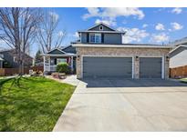 Charming two-story home with a three-car garage and a beautifully landscaped front yard at 529 Olympia Ave, Longmont, CO 80504