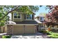 Charming two-story home features a well-manicured lawn, brick accents and attached two-car garage at 2980 E 135Th Dr, Thornton, CO 80241