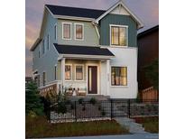 Charming two-story home with a cozy front porch and professionally landscaped yard at 6244 N Lisbon St, Aurora, CO 80019