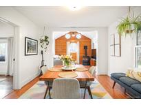 Inviting dining room featuring natural light, wood floors, table for four, and stylish decor at 1232 Wabash St, Denver, CO 80220