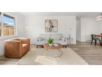 Bright living room features modern decor, neutral color palette, stylish furnishings, and plenty of natural light at 3313 Jasmine St, Denver, CO 80207