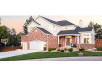 Charming two-story home with brick and siding, attached garage, basketball hoop, and beautifully landscaped front yard at 16658 Black Oak Ct, Parker, CO 80134