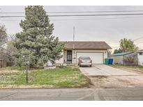 Charming home featuring a mature tree, inviting curb appeal, and an attached two-car garage at 6132 S Grant St, Centennial, CO 80121