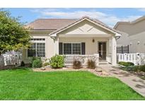 Charming single-story home featuring a well-maintained lawn and a cozy front porch at 11816 Zenobia Loop, Westminster, CO 80031