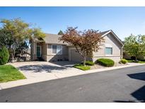 Charming ranch-style home with attached garage, beautiful landscaping, and inviting curb appeal at 9567 Brentwood Way # A, Broomfield, CO 80021