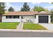 Charming ranch home with a newly painted exterior, landscaped lawn, and attached garage at 536 W Caley Cir, Littleton, CO 80120