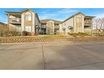 Attractive exterior of a two-story townhome with stone accents and balconies at 10381 Cook Way # 205, Thornton, CO 80229