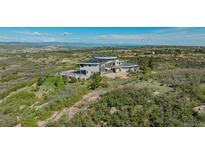 Stunning modern home boasts sleek design and breathtaking mountain views from its hilltop location at 1175 Ridge Oaks Dr, Castle Rock, CO 80104